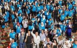 Participants in the 'White Card Day' event -- the global United Nations "International Day of Sport for Development and Peace" -- held in Israel for the first time on April 7, 2019, hold up their white cards. (Jordan Polevoy)