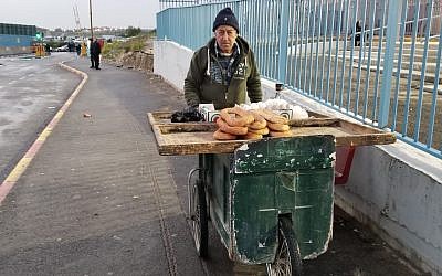 64-year-old Abu Ramzi, a merchant, stands outside the new Qalandiya checkpoint in northern Jerusalem on March 16, 2019. (Adam Rasgon/Times of Israel)