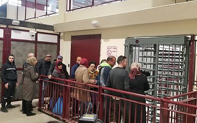 Palestinians at the new Qalandiya checkpoint on March 26, 2019, waiting their turn to pass through turnstiles and metal detectors. (Adam Rasgon/Times of Israel)