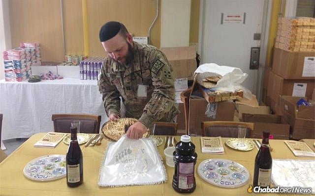US Army Capt. Mendy Stern, chaplain for the 312th Military Intelligence Battalion, sets up for a Passover seder for Jewish troops serving in Afghanistan. (Courtesy, Chabad) US Army Capt. Mendy Stern, chaplain for the 312th Military Intelligence Battalion, sets up for a Passover seder for Jewish troops serving in Afghanistan. (Courtesy, Chabad)