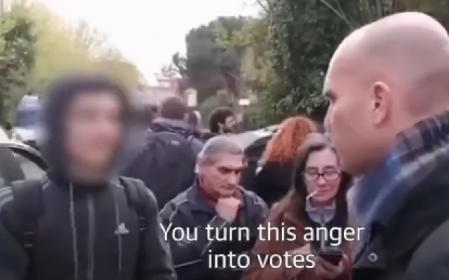 An Italian teen (L) confronts a far-right protester in the Rome suburb of Torre Maura in a video that went viral, on April 2, 2019 (screenshot) An Italian teen (L) confronts a far-right protester in the Rome suburb of Torre Maura in a video that went viral, on April 2, 2019 (screenshot)