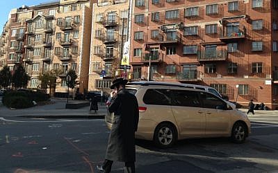 A US ultra-Orthodox man crosses the street in Williamsburg, Brooklyn, New York. (Gil Shefler via JTA)