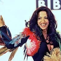 Dana International, Israel's 1998 winner, in her iconic feathered dress, on display at an exhibit open for Eurovision 2019. (Courtesy)