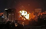 An explosion is seen among buildings during an Israeli airstrike on Gaza City in response to rocket fire from the Palestinian enclave on May 4, 2019. (Mahmud Hams/AFP)