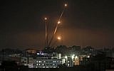 Illustrative: A picture taken in Gaza City on May 5, 2019, shows rockets being fired toward Israel. (Mahmud Hams/AFP)