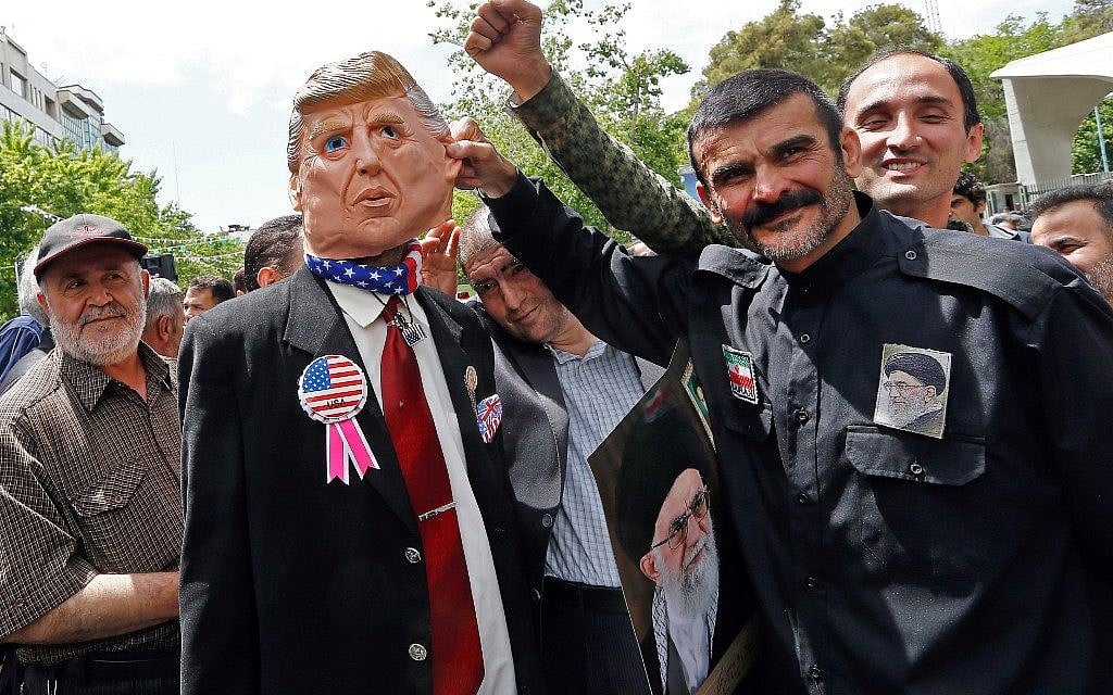 Iranian demonstrators carry a portrait of Iran's Supreme Leader Ayatollah Ali Khamenei and an effigy of US President Donald Trump, during a rally in the capital Tehran, on May 10, 2019. (Stringer/AFP)