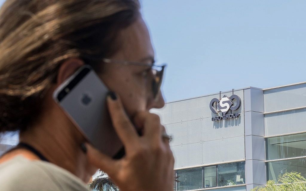 An Israeli woman uses her phone in front of a building in Herzliya that housed the NSO Group intelligence firm, August 28, 2016. (Jack Guez/AFP/File) An Israeli woman uses her phone in front of a building in Herzliya that housed the NSO Group intelligence firm, August 28, 2016. (Jack Guez/AFP/File)