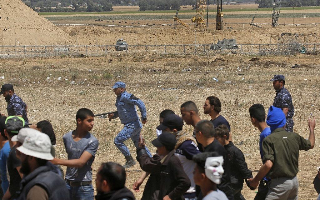 Palestinian Hamas police block protesters from reaching the border fence east of Khan Yunis in the southern Gaza Strip on May 15, 2019. (Photo by Said KHATIB / AFP)