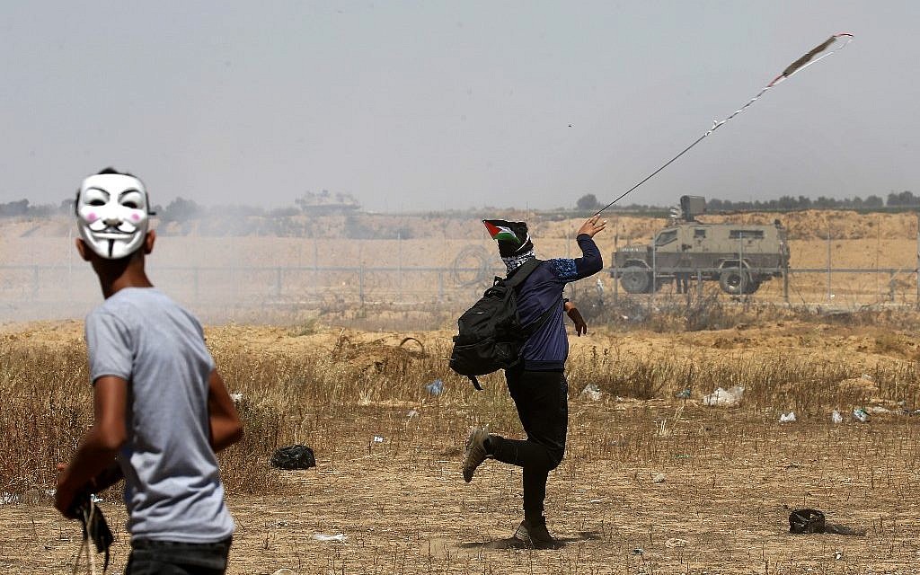 Palestinian demonstrators hurl rocks towards Israeli soldiers east of Khan Yunis in the southern Gaza Strip on May 15, 2019, during a protest marking 71th anniversary of Nakba (Said KHATIB / AFP)
