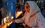 A Jewish pilgrim lights a candle on the first day of the annual Jewish pilgrimage to the El Ghriba Synagogue, Africa's oldest, on Tunisia's Mediterranean resort island of Djerba on May 22, 2019. (Fathi Nasri/AFP)