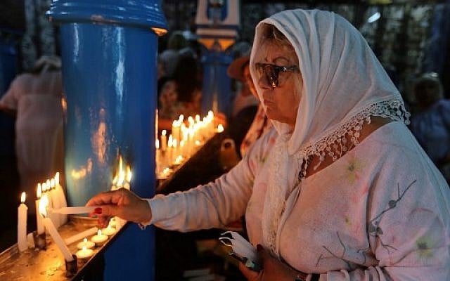 A Jewish pilgrim lights a candle on the first day of the annual Jewish pilgrimage to the El Ghriba Synagogue, Africa's oldest, on Tunisia's Mediterranean resort island of Djerba on May 22, 2019. (Fathi Nasri/AFP) A Jewish pilgrim lights a candle on the first day of the annual Jewish pilgrimage to the El Ghriba Synagogue, Africa's oldest, on Tunisia's Mediterranean resort island of Djerba on May 22, 2019. (Fathi Nasri/AFP)