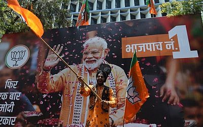 An Indian supporter of Indian Prime Minister Narendra Modi's Bharatiya Janata Party (BJP) celebrates the election results outside the BJP headquarters in Mumbai on May 23, 2019.  (Punit Paranjpe/AFP)