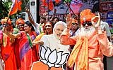 Indian supporters and party workers of the Bharatiya Janata Party (BJP) in Bangalore dance and hold flags as they celebrate the results of India's general election on May 23, 2019. (Manjunath Kiran/AFP)