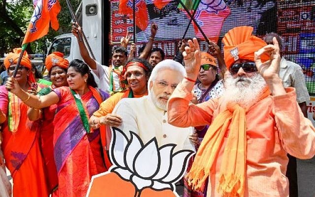 Indian supporters and party workers of the Bharatiya Janata Party (BJP) in Bangalore dance and hold flags as they celebrate the results of India's general election on May 23, 2019. (Manjunath Kiran/AFP) Indian supporters and party workers of the Bharatiya Janata Party (BJP) in Bangalore dance and hold flags as they celebrate the results of India's general election on May 23, 2019. (Manjunath Kiran/AFP)