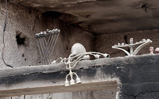 Candle holders are scattered in a house that was badly damaged by fire amidst extreme heat wave in the village of Mevo Modiim, in central Israel on May 24, 2019. (Photo by JACK GUEZ / AFP)
