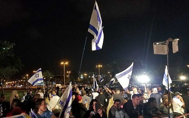 Demonstrators protest in Tel Aviv outside a joint Memorial Day event for bereaved Israeli and Palestinian families on May 7, 2019. (Adam Rasgon/Times of Israel)