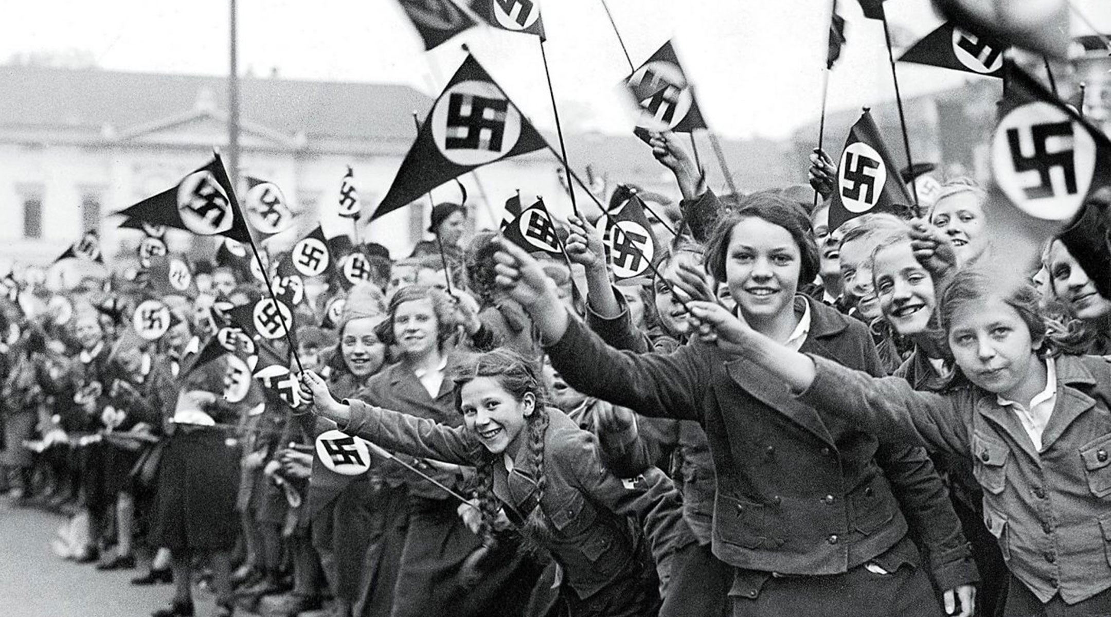 Austrian members of the League of German Girls wave Nazi flags in support of the German annexation of Austria, in Vienna, March 1938. (US Holocaust Memorial Museum) Austrian members of the League of German Girls wave Nazi flags in support of the German annexation of Austria, in Vienna, March 1938. (US Holocaust Memorial Museum)