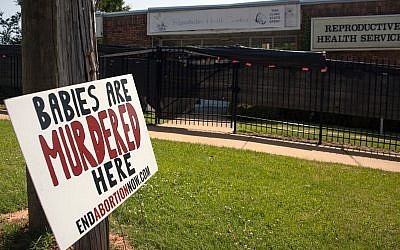 An anti-abortion sign is placed outside of the Reproductive Health Services building in Montgomery, Alabama, on May 20, 2019.  (Seth HERALD / AFP/Getty Images)