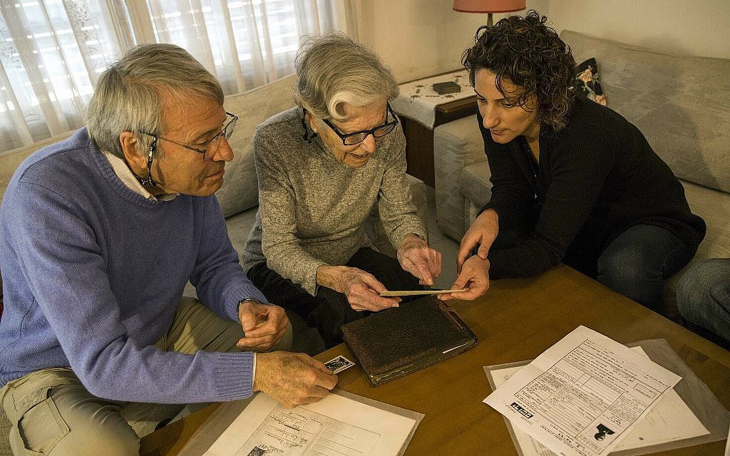 In this photo from April 23, 2019, Israeli Holocaust survivors Rachel Zeiger 91, center, and her brother Moshe Akerman 84, left, speak with Orit Noiman, head of Yad Vashem's collection and registration center, at their home in the Tel Aviv suburb of Ramat Gan. (AP Photo/Tsafrir Abayov) In this photo from April 23, 2019, Israeli Holocaust survivors Rachel Zeiger 91, center, and her brother Moshe Akerman 84, left, speak with Orit Noiman, head of Yad Vashem's collection and registration center, at their home in the Tel Aviv suburb of Ramat Gan. (AP Photo/Tsafrir Abayov)