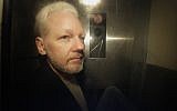 WikiLeaks founder Julian Assange being taken from court, where he appeared on charges of jumping British bail seven years ago, in London, on May 1, 2019. (AP Photo/Matt Dunham)