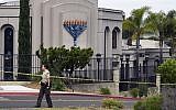A San Diego county sheriff's deputy stands in front of the Poway Chabad Synagogue in Poway, California, April 28, 2019, after a shooting. (AP /Denis Poroy)