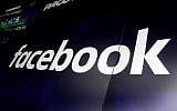 In this file photo from March 29, 2018, the logo for Facebook appears on screens at the Nasdaq MarketSite, in New York's Times Square. (AP Photo/Richard Drew, File)