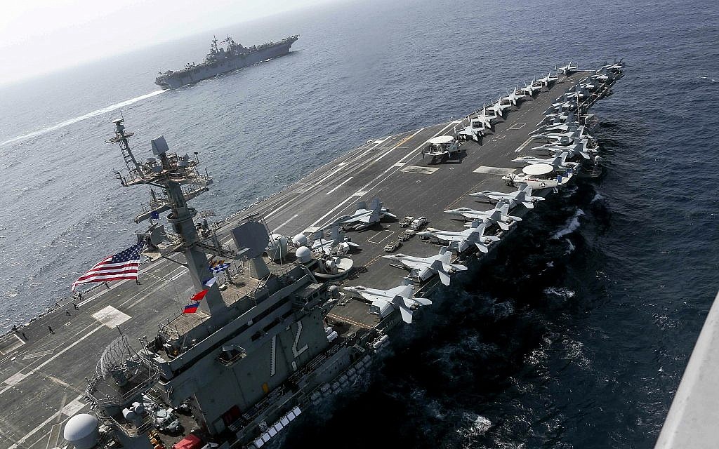 In this May 17, 2019, photo released by the US Navy, the USS Abraham Lincoln sails in the Arabian Sea near the amphibious assault ship USS Kearsarge. (Mass Communication Specialist 1st Class Brian M. Wilbur, US Navy via AP)
