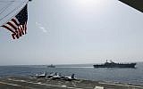 In this Friday, May 17, 2019, photo, released by the US Navy, the amphibious assault ship USS Kearsarge, right, and the Arleigh Burke-class guided-missile destroyer USS Bainbridge, left, are seen from the Nimitz-class aircraft carrier USS Abraham Lincoln as they sail in the Arabian Sea. (Mass Communication Specialist Seaman Michael Singley, US Navy via AP)