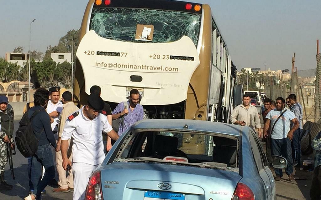 Police inspect a car and a bus that were damaged by an explosion, in Cairo, Egypt, Sunday, March 19, 2019. (AP/Mohammed Salah)