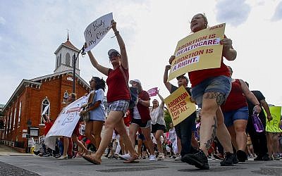 Protesters for women's rights march past Dexter Avenue Baptist Church to the Alabama Capitol to protest a law passed last week making abortion a felony in nearly all cases with no exceptions for cases of rape or incest, Sunday, May 19, 2019, in Montgomery, Ala. (AP Photo/Butch Dill)