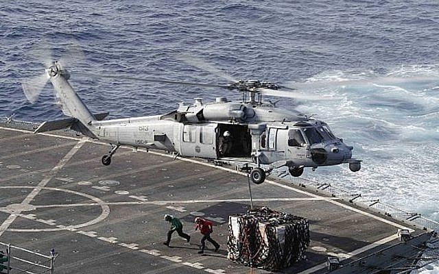 An MH-60S Sea Hawk helicopter transports cargo from the fast combat support ship USNS Arctic to the Nimitz-class aircraft carrier USS Abraham Lincoln during a replenishment-at-sea operation in the Arabian Sea, May 19, 2019. (Mass Communication Specialist 3rd Class Darion Chanelle Triplett/U.S. Navy via AP) An MH-60S Sea Hawk helicopter transports cargo from the fast combat support ship USNS Arctic to the Nimitz-class aircraft carrier USS Abraham Lincoln during a replenishment-at-sea operation in the Arabian Sea, May 19, 2019. (Mass Communication Specialist 3rd Class Darion Chanelle Triplett/U.S. Navy via AP)