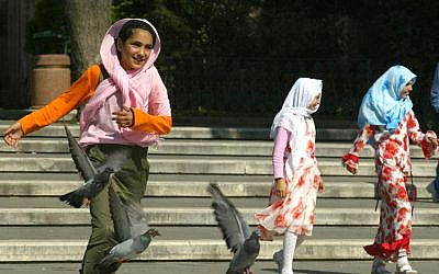 ILLUSTRATIVE: Girls wearing Islamic headscarves play in a park in  Istanbul, Turkey, July 22, 2004 (AP Photo/Osman Orsal)