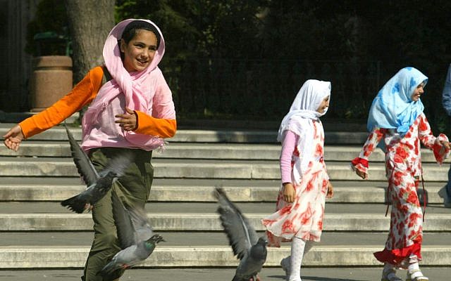 ILLUSTRATIVE: Girls wearing Islamic headscarves play in a park in Istanbul, Turkey, July 22, 2004 (AP Photo/Osman Orsal) ILLUSTRATIVE: Girls wearing Islamic headscarves play in a park in Istanbul, Turkey, July 22, 2004 (AP Photo/Osman Orsal)