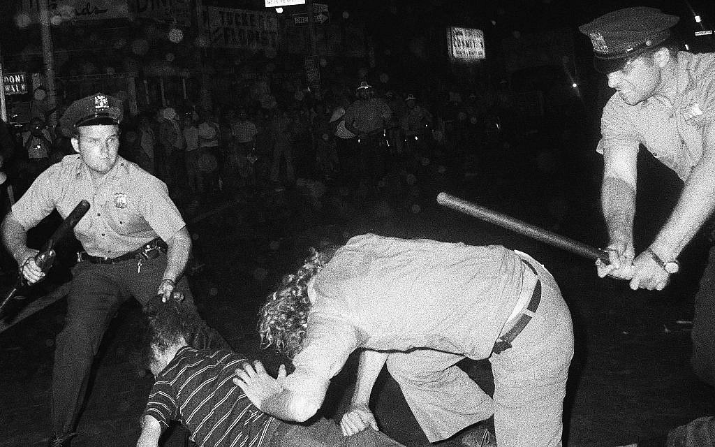 Illustrative: In this August 31, 1970 file photo, a NYPD officer grabs a youth by the hair as another officer clubs a young man during a confrontation in Greenwich Village after a Gay Power march in New York. (AP Photo/File)