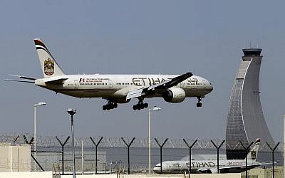 In this May 4, 2014, photo, an Etihad Airways plane prepares to land at the Abu Dhabi airport in the United Arab Emirates (AP Photo/Kamran Jebreili)