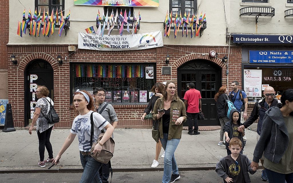 Illustrative: People pass the Stonewall Inn, Wednesday, October 11, 2017, in New York. (AP Photo/Mark Lennihan)