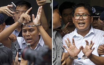 Reuters journalists Kyaw Soe Oo, left, and Wa Lone, are handcuffed as they are escorted by police out of the court Monday, Sept. 3, 2018, in Yangon, Myanmar after being sentenced to seven years in prison. (AP /Thein Zaw)