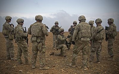 In this November 7, 2018, photo released by the US Army, US soldiers gather for a brief during a combined joint patrol rehearsal in Manbij, Syria (US Army photo by Spc. Zoe Garbarino via AP)