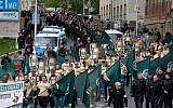 Illustrative: Protesters march with flags during a demonstration of the far-right party 'The third way' in Plauen, Germany, Wednesday, May 1, 2019. (Sebastian Willnow/dpa via AP)