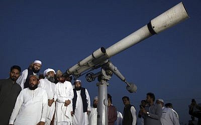 Clerics of Pakistan's Moon Sighting Committee search the sky with a telescope for the new moon that signals the start of the Muslim fasting month of Ramadan, in Karachi, May 5, 2019. (AP/Fareed Khan) Clerics of Pakistan's Moon Sighting Committee search the sky with a telescope for the new moon that signals the start of the Muslim fasting month of Ramadan, in Karachi, May 5, 2019. (AP/Fareed Khan)