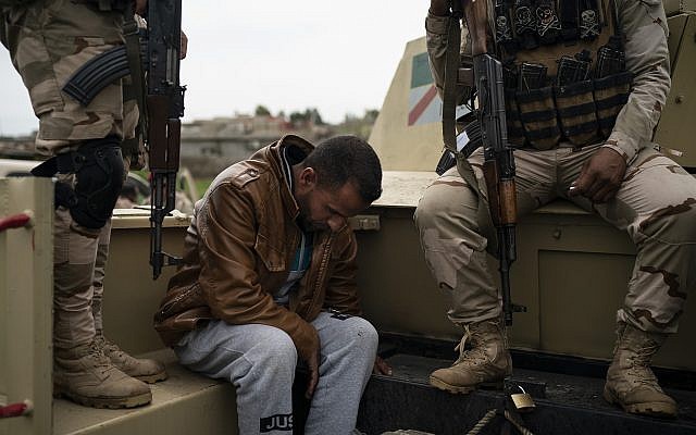 In this April 5, 2019 photo, a man is taken for questioning by Iraqi army 20th division soldiers during a raid in Badoush, Iraq. (AP Photo/Felipe Dana) In this April 5, 2019 photo, a man is taken for questioning by Iraqi army 20th division soldiers during a raid in Badoush, Iraq. (AP Photo/Felipe Dana)