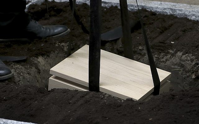 A cemetery staff member lets down a box with the remains of political prisoners of the Nazi regime in Berlin, Germany, Monday, May 13, 2019. (AP Photo/Michael Sohn) A cemetery staff member lets down a box with the remains of political prisoners of the Nazi regime in Berlin, Germany, Monday, May 13, 2019. (AP Photo/Michael Sohn)