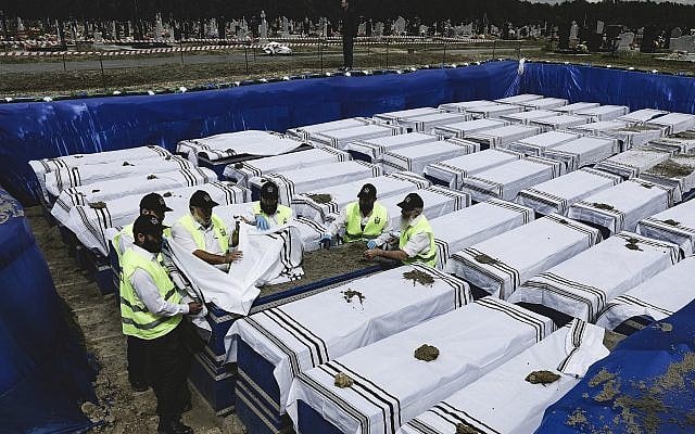 ZAKA volunteers perform the final rites before burying the remains of Holocaust victims at a cemetery just outside Brest, Belarus, on May 22, 2019. (Uladz Hrydzin, Radio Free Europe/Radio Liberty via AP) ZAKA volunteers perform the final rites before burying the remains of Holocaust victims at a cemetery just outside Brest, Belarus, on May 22, 2019. (Uladz Hrydzin, Radio Free Europe/Radio Liberty via AP)