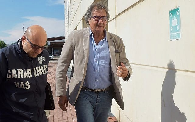 Dr. Guido Fanelli (right) entering police headquarters in Parma, Italy, for questioning in an alleged pharmaceutical kickback scheme, May 8, 2017. (AP/Marco Vasini)