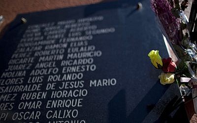 Illustrative: Plastic flowers sit placed on a memorial stone in tribute to Argentine soldiers who were killed during the Falklands war, in Buenos Aires, Argentina, April 8, 2013. (AP Photo/Natacha Pisarenko)