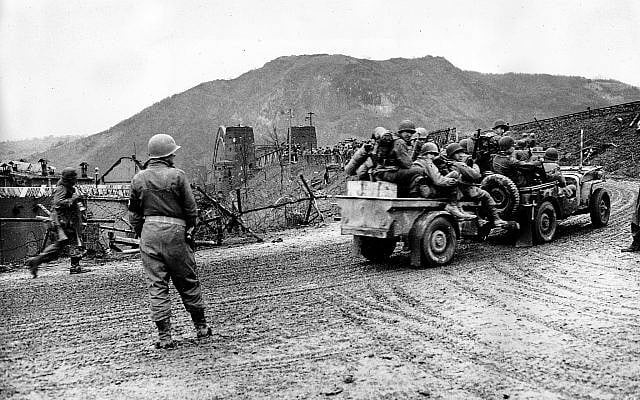Illustrative: Troops of the 9th US Armored Division, First Army, advance across the intact Ludendorff Bridge to the east bank of the Rhine River in Remagen, Germany, on March 7, 1945 during World War II. (AP Photo/Allan Jackson) Illustrative: Troops of the 9th US Armored Division, First Army, advance across the intact Ludendorff Bridge to the east bank of the Rhine River in Remagen, Germany, on March 7, 1945 during World War II. (AP Photo/Allan Jackson)