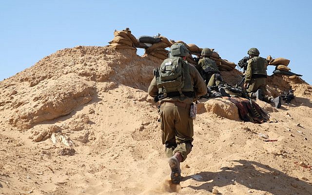 Israeli soldiers stand guard along the Gaza border east of the city of Rafah in the southern Strip during Nakba Day protests on May 15, 2019. (Judah Ari Gross/Times of Israel)