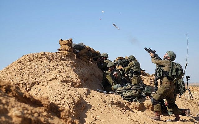 An Israeli soldier fires a tear gas canister at rioters east of the Gaza city of Rafah in the southern Strip during Nakba Day protests on May 15, 2019. (Judah Ari Gross/Times of Israel)