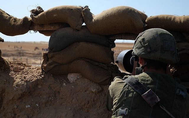 Israeli soldiers stand guard along the Gaza border east of the city of Rafah in the southern Strip during Nakba Day protests on May 15, 2019. (Judah Ari Gross/Times of Israel)
