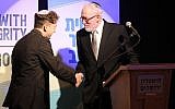 Newly ordained Rabbi Daniel Atwood is congratulated by Rabbi Daniel Landes at the Jerusalem Theater, on May 26, 2019. (Sam Sokol/JTA)